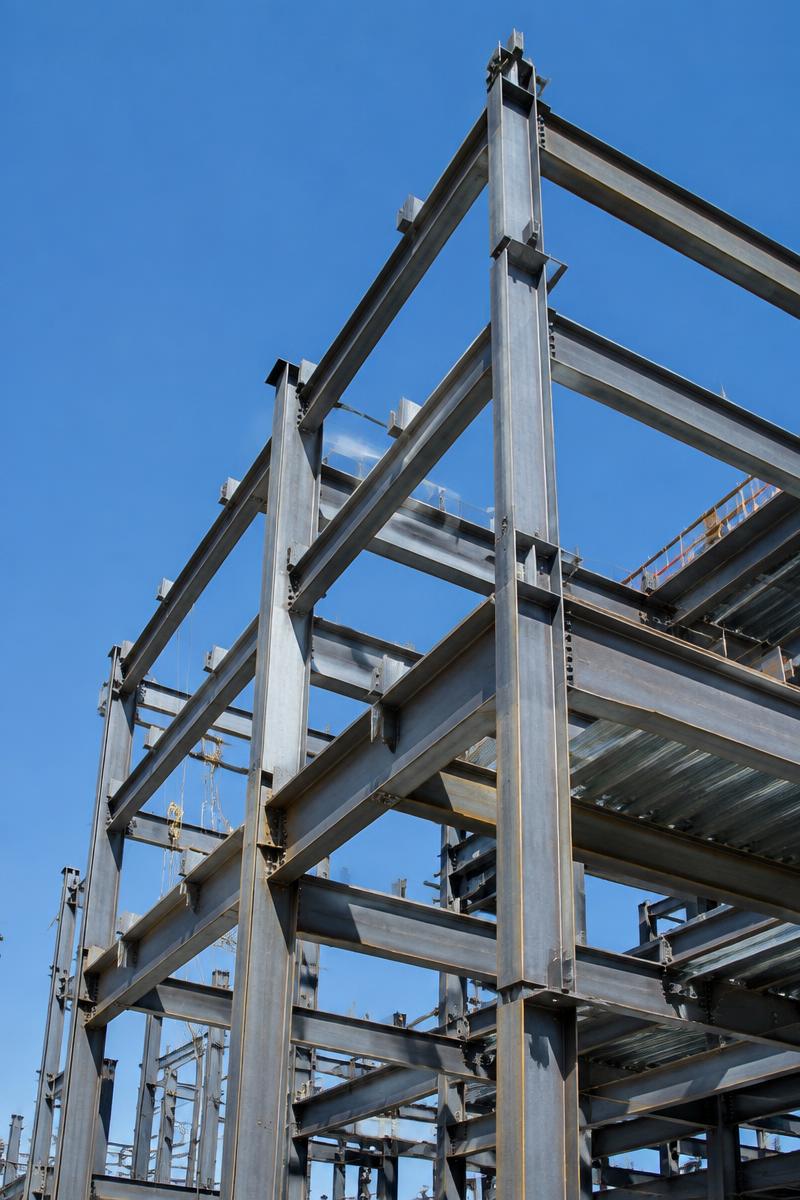 Steel building columns and framing against a blue sky